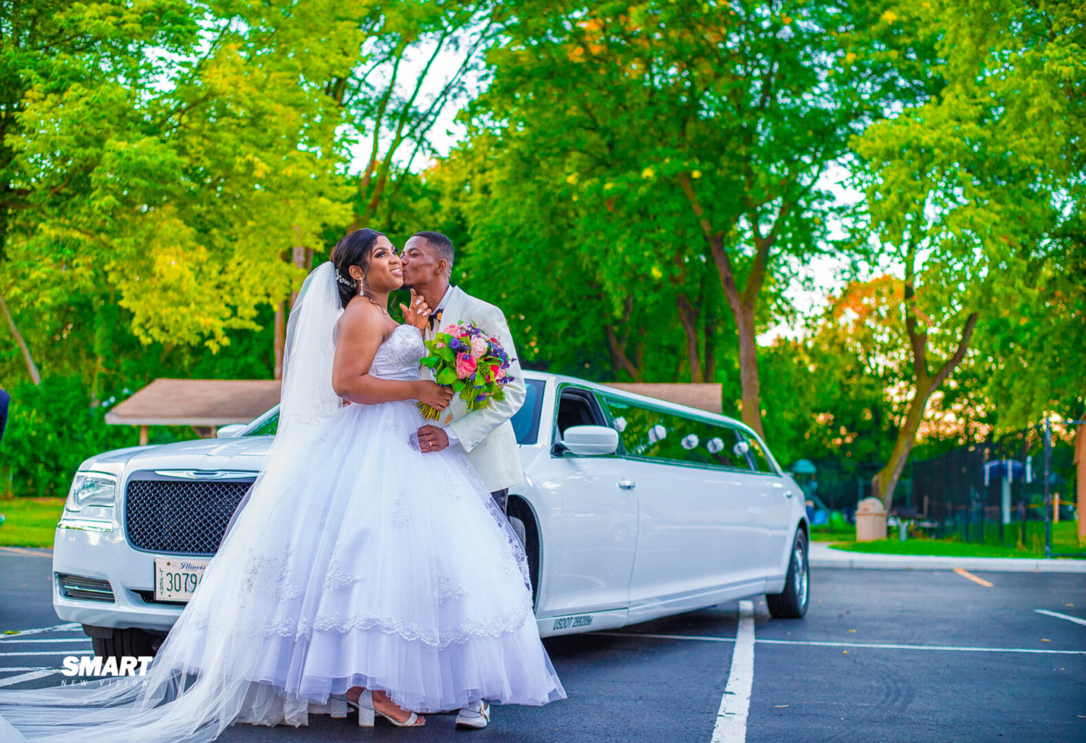 Bride and groom with limousine